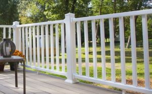 Modern home with a sturdy horizontal metal and wood combination fence, highlighting durable fence materials for homes with style and strength.