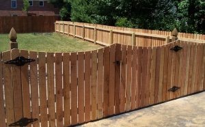 Simple wooden backyard fence offering privacy and curb appeal, representing an affordable fence installation for residential properties.