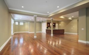 Spacious modern interior with glossy hardwood floors and recessed lighting, showcasing the results of the best flooring services for high-end residential spaces.