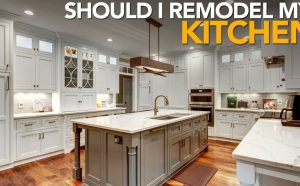 Elegant modern kitchen with a large island, white cabinetry, and stylish lighting, highlighting professional kitchen remodeling services for a functional upgrade.