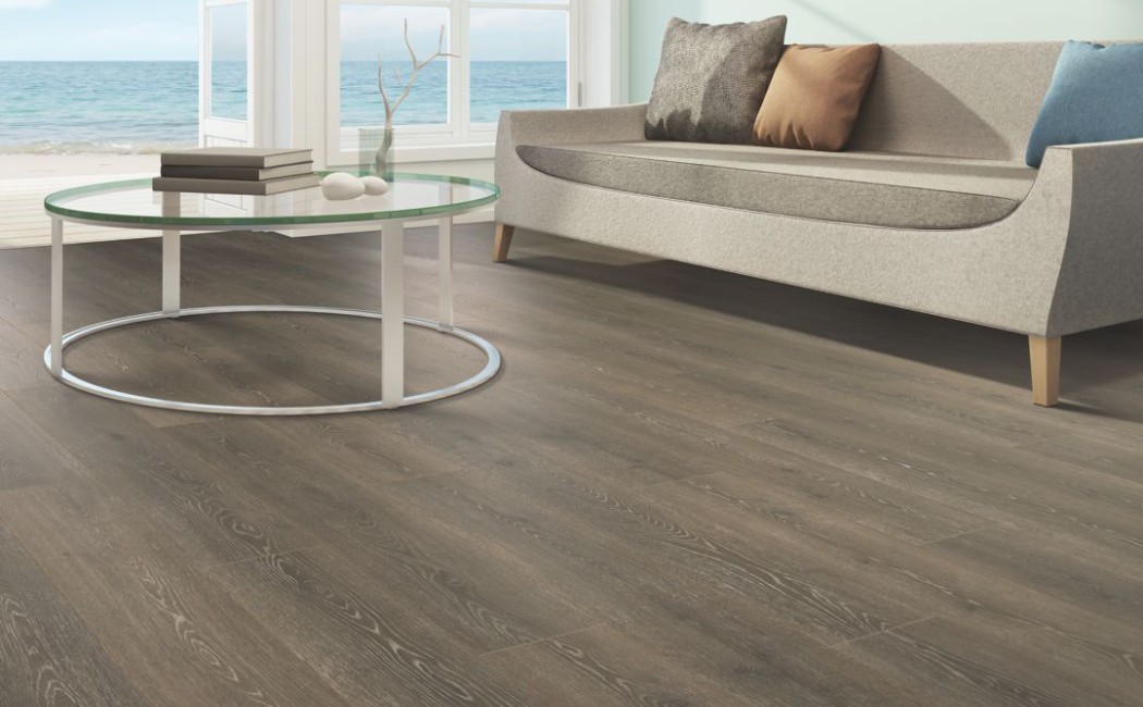 A modern living room with stylish laminate flooring, featuring a sleek coffee table and comfortable sofa. Enhance your space with a trusted laminate flooring company for beautiful results.