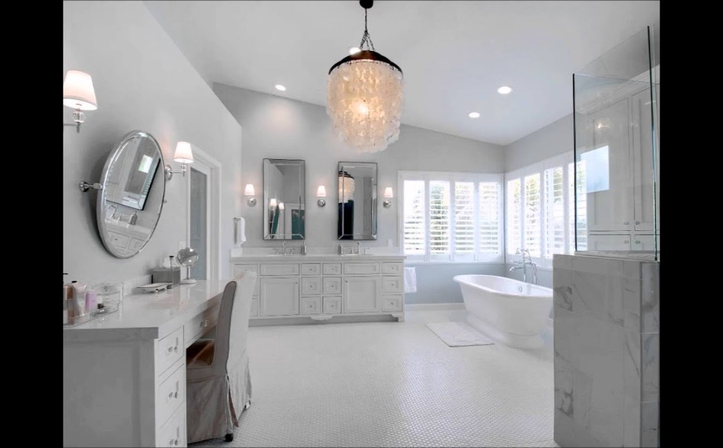 A bright, modern bathroom with a freestanding tub, double vanities, and elegant lighting, an inspiring example of Bathroom Remodelling Services. Sleek white finishes and spacious design showcase a luxurious remodel.