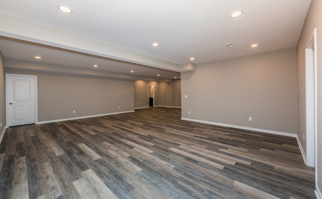 Modern LVP Flooring by a Professional LVP Flooring Company Spacious finished interior featuring modern luxury vinyl plank flooring installed by a professional LVP Flooring Company, offering durability, style, and a clean, seamless look.