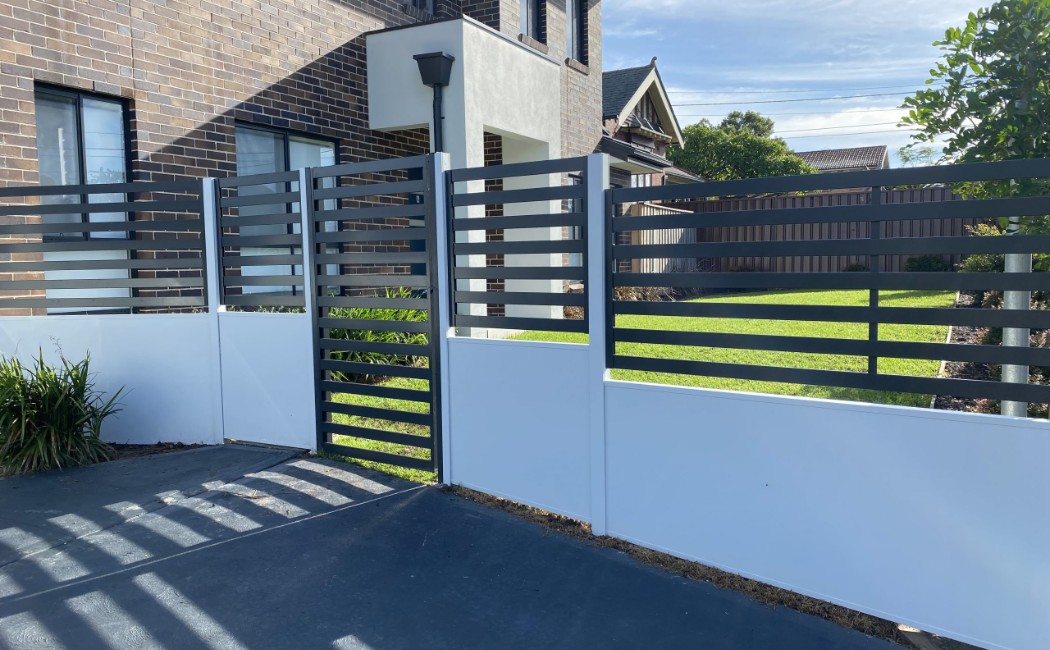 Modern Horizontal Slat Fence Installation by Professional Fence Builders Modern horizontal slat fence and gate installed outside a contemporary home, highlighting professional Fence Building Services.