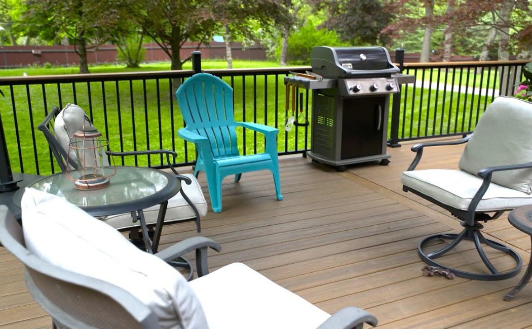 Expert Deck Maintenance Services for Beautiful Outdoor Living Clean and well-maintained backyard deck with patio furniture and grill, showcasing professional Deck Maintenance Services for lasting beauty and durability.