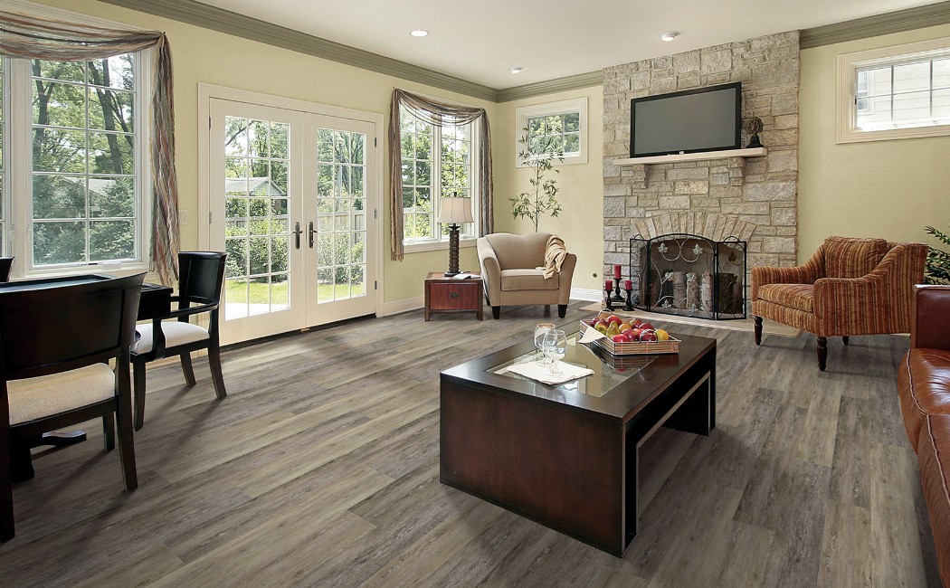 Spacious living room with elegant furniture and wood-look floors installed by a trusted LVP Flooring Company, showcasing durable luxury vinyl plank flooring.