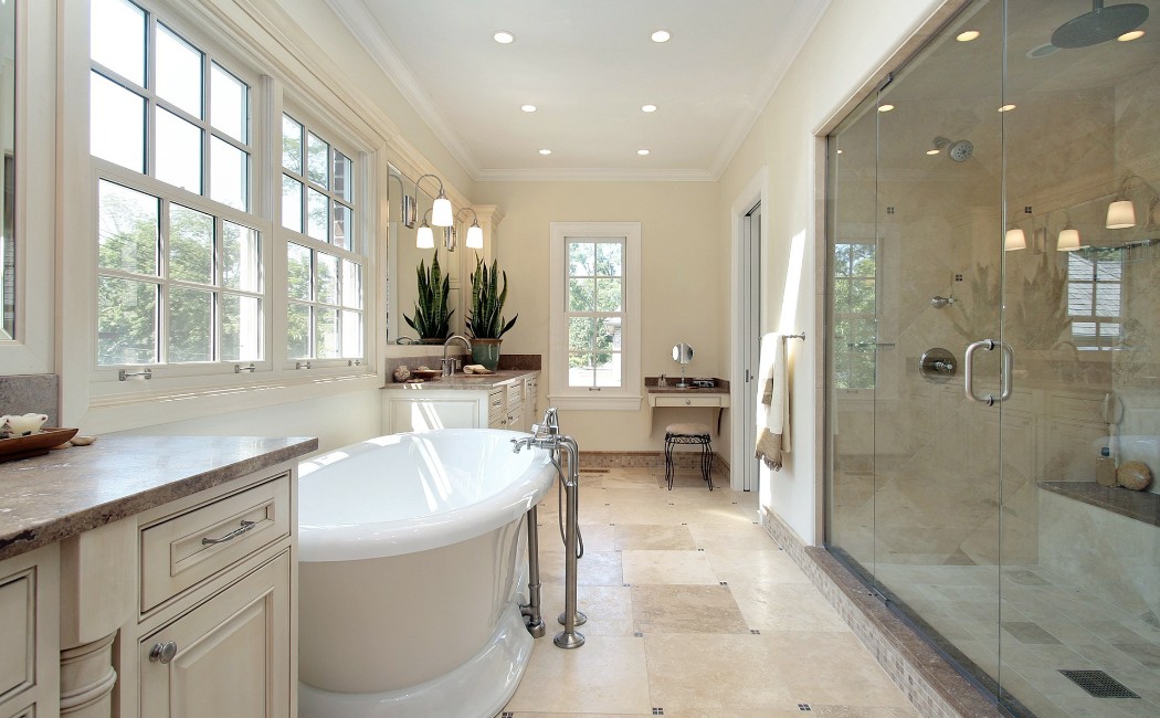 Bright and spacious interior featuring a freestanding tub, glass walk-in shower, large windows, and elegant fixtures, highlighting a stylish and functional Bathroom Remodeling design.