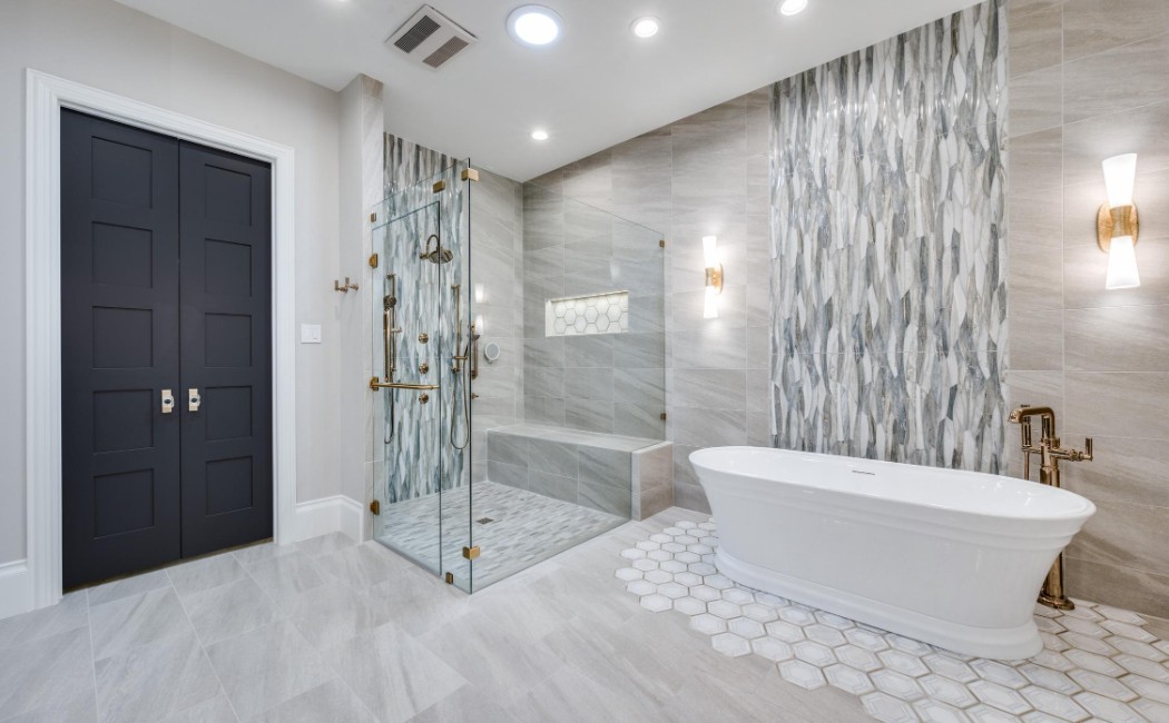 Bathroom Remodeling showcasing a modern bathroom with a freestanding tub and glass walk-in shower, featuring elegant marble tile walls, bright lighting, and gold fixtures for a luxurious spa-like design.