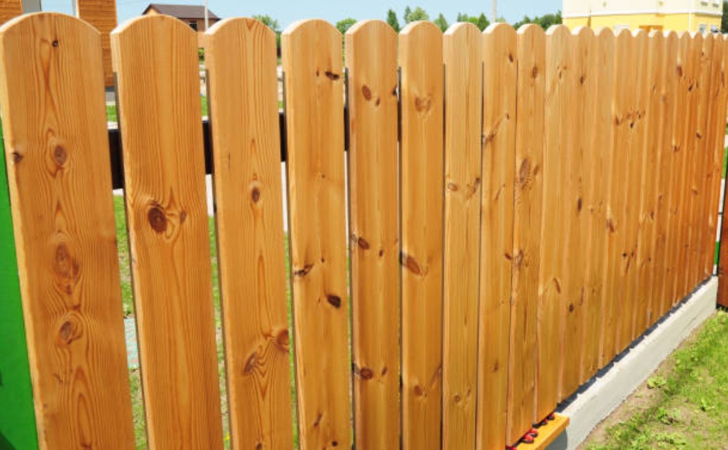 Freshly installed wooden privacy fence panels aligned neatly during a Fence Installation and Repair project.
