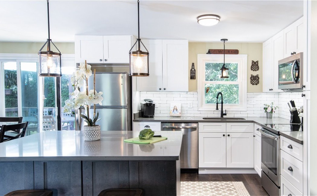 Bright modern kitchen with white cabinets, stainless steel appliances, and a spacious island, showcasing stylish Kitchen Remodeling Services for a functional and elegant home upgrade.