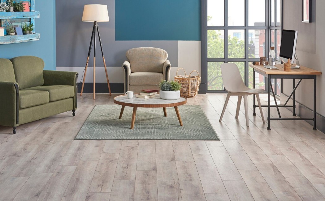 Elegant living room and workspace featuring stylish furniture and wood-look floors installed by a professional LVP Flooring Company, highlighting durable luxury vinyl plank flooring.